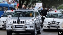 FILE - In this Oct. 18, 2014 file photo, former chief minister of India's Tamil Nadu state Jayaram Jayalalitha travels in a car accompanied by a row of cars with red beacon lights after being released from a prison in Bangalore, India.