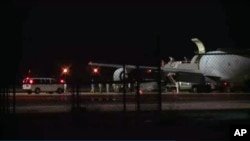 In this image from video people are greeted on arrival at Lackland Air Force Base in San Antonio Texas early Friday morning June 13, 2014.