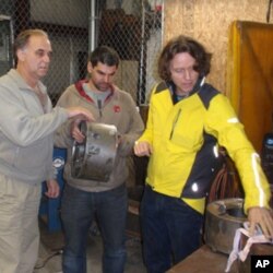 BURN Design Lab founder Peter Scott (right) examines prototypes with Lou Fezio (far left) and Mike Oldani