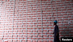 A worker walks past boxes of therapeutic food to be distributed to the malnourished population inside the United Nations International Children's Emergency Fund (UNICEF) warehouse in Ethiopia's capital Addis Ababa, April 22, 2016.