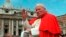 FILE - In this file photo taken on April 23, 1997, Pope John Paul II waves to faithful as he crosses St. Peter's Square at the Vatican.