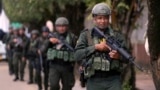 (FILE) Police patrol in Tibu, Colombia, Tuesday, Jan. 21, 2025, following guerrilla attacks that have killed dozens of people and forced thousands to flee their homes in the Catatumbo region.