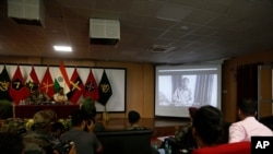 FILE - Journalists watch a confessional video of a Lashkar-e-Taiba militant at a press conference in Srinagar, India, Sept. 4, 2019. Pakistan said June 18, 2020, that four LeT leaders linked to attacks in India had been convicted of terrorism funding.