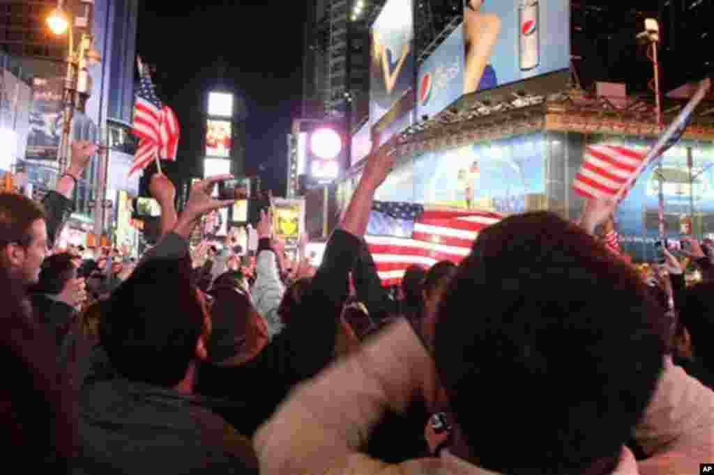 A crowd gathered in New York's Times Square reacts to the news of Osama Bin Laden's death early Monday morning, May 2, 2011 (AP)