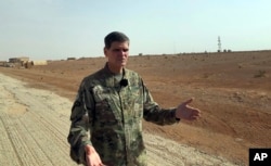 FILE - U.S. Gen. Joseph Votel, top U.S. commander in the Middle East, speaks to reporters during an unannounced visit to a military outpost in southern Syria, Oct. 22, 2018.