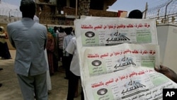A Sudanese man holds three archive copies of 'Rai al-Shaab' newspaper which was confiscated, 16 May 2010.