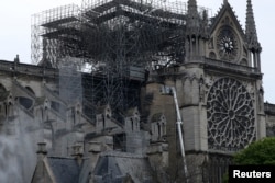 Firefighters work at Notre-Dame Cathedral in Paris, France April 16, 2019. A massive fire consumed the cathedral on Monday, gutting its roof and stunning France and the world. REUTERS/Yves Herman