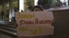 A demonstrator holds a poster reading "We are for Dima Yakovlev Bill" outside the Federation Council, December 26, 2012. 