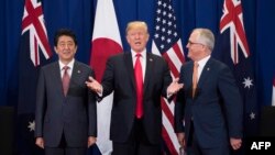 Japan's Prime Minister Shinzo Abe, left, U.S. President Donald Trump and Australia Prime Minister Malcolm Turnbull attend a trilateral meeting during the opening ceremony of the 31st Association of South East Asian Nations (ASEAN) Summit in Manila on Nove