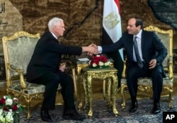 FILE - U.S. Vice President Mike Pence shakes hands with Egyptian President Abdel-Fattah el-Sissi at the Presidential Palace in Cairo, Jan. 20, 2018.