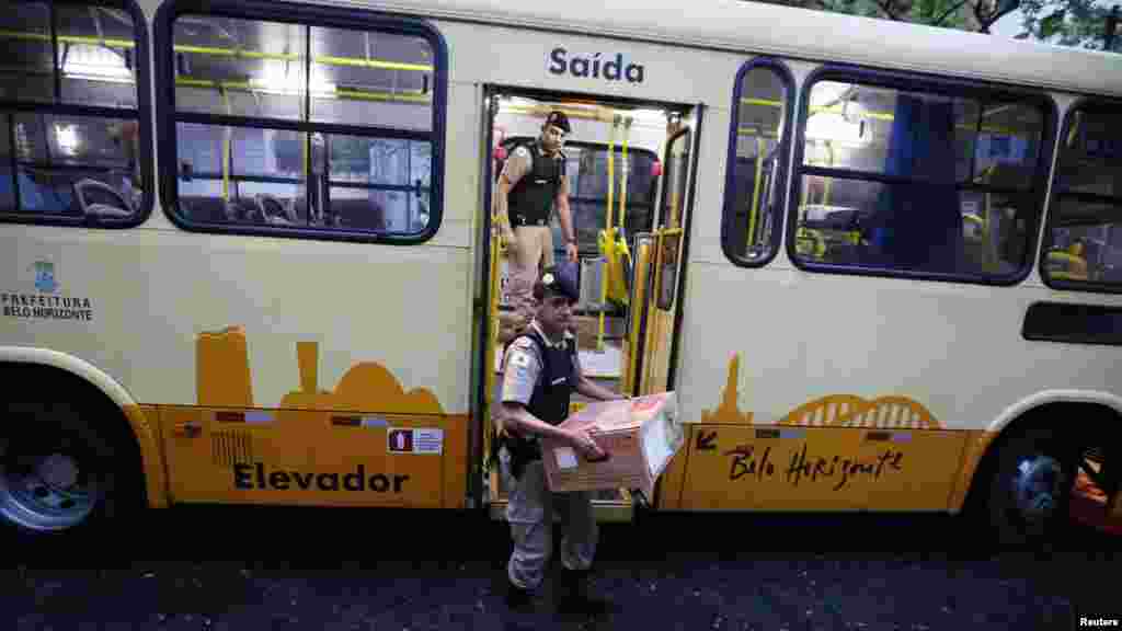 electronic ballot boxes from a bus to a voting station before polls opened in the runoff presidential election in Belo Horizonte, Oct. 26, 2014
