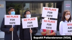 A group of Asian communities holds signs during a press conference calling to a halt on violence against Asian Americans in Los Angeles, CA March 23, 2021