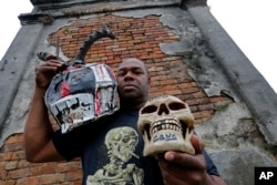 Bruce "Sunpie" Barnes, head of the Mardi Gras North Side Skull & Bone Gang, poses with his accoutrements for Mardi Gras day, in a cemetery in New Orleans, Jan. 7, 2016.