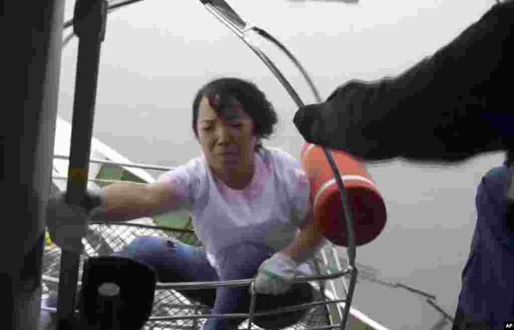 This image made from video from the South Korean Coast Guard shows a passenger of a ferry sinking off South Korea's southern coast being hoisted onto a Coast Guard helicopter off the southern coast near Jindo, April 16, 2014.