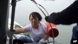 This image made from video from the South Korean Coast Guard shows a passenger of a ferry sinking off South Korea's southern coast being hoisted onto a Coast Guard helicopter off the southern coast near Jindo, April 16, 2014.