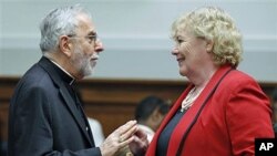 Bishop Gerald Kicanas (L), Archdiocese of Tucson, Arizona, speaks with House Judiciary subcommittee on Immigration, Citizenship, Refugees, Border Security, and International Law Chair Zoe Lofgren, before a panel hearing about reform of the US immigration 