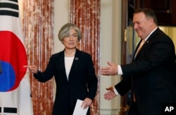 South Korean Foreign Minister Kang Kyung-wha, left, and Secretary of State Mike Pompeo arrive for press conference at the State Department, May 11, 2018, in Washington.