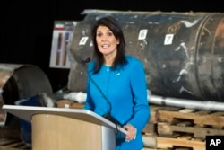 FILE - U.S. Ambassador to the U.N. Nikki Haley speaks in front of recovered segments of an Iranian rocket during a press briefing at Joint Base Anacostia-Bolling, Dec. 14, 2017, in Washington.