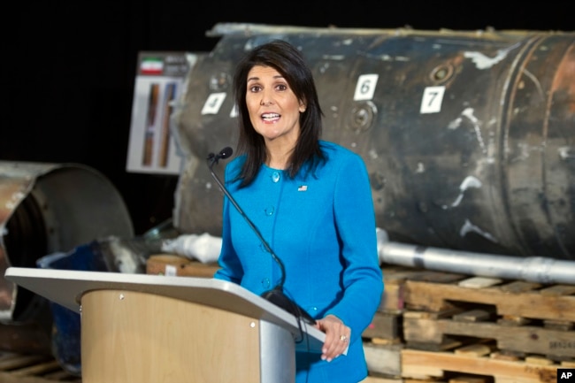 FILE - U.S. Ambassador to the U.N. Nikki Haley speaks in front of recovered segments of an Iranian rocket during a press briefing at Joint Base Anacostia-Bolling, Dec. 14, 2017, in Washington.