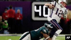Philadelphia Eagles defensive end Brandon Graham (55) tackles New England Patriots quarterback Tom Brady (12), during the first half of the NFL Super Bowl 52 football game, Sunday, Feb. 4, 2018, in Minneapolis.