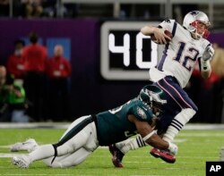 Philadelphia Eagles defensive end Brandon Graham (55) tackles New England Patriots quarterback Tom Brady (12), during the first half of the NFL Super Bowl 52 football game, Sunday, Feb. 4, 2018, in Minneapolis.