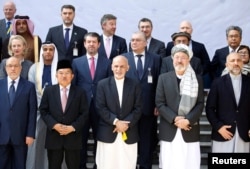 FILE - Afghan President Ashraf Ghani poses for a group photo during a peace and security cooperation conference in Kabul, Afghanistan, Feb. 28, 2018.