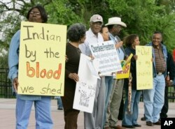 FILE - Waynetta Lawrie, left, of Tulsa, Oklahoma, stands with others at the state Capitol in Oklahoma City during a demonstration by several Cherokee Freedmen and their supporters, March 27, 2007.