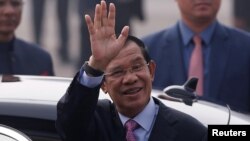 Cambodia's Prime Minister Hun Sen waves upon his arrival at Air Force Station Palam in New Delhi, India, Jan. 24, 2018.