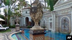David Tamuty of Fort Lauderdale, Fla., lounges in the swimming pool at The Villa Casa Casuarina, a boutique hotel that once was the home of fashion designer Gianni Versace, in Miami Beach, Fla., Dec. 26, 2017. 