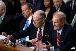 Sen. Bill Nelson, D-Fla., right, accompanied by Sen. John Thune, R-S.D., left, and Sen. Chuck Grassley, R-Iowa, second from left, speaks as Facebook CEO Mark Zuckerberg testifies before a joint hearing of the Commerce and Judiciary committees on Capitol Hill in Washington, April 10, 2018, about the use of Facebook data to target American voters in the 2016 election.