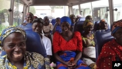FILE - Family members of the Nigerian Chibok kidnapped girls share a moment as they depart to the Nigerian minister of women affairs in Abuja, Nigeria, Oct. 18, 2016. Nigeria's government is negotiating the release of another 83 of the Chibok schoolgirls taken in a mass abduction in 2014.