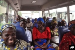 FILE - Family members of the Nigerian Chibok kidnapped girls share a moment as they depart to the Nigerian minister of women affairs in Abuja, Nigeria, Oct. 18, 2016.