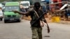 A mutinying soldier gestures as he stands guard at the checkpoint of the entrance of Bouake, Ivory Coast, May 15, 2017. 