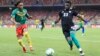 FILE - Cameroon's Clinton Njie (L) vies for the ball with Rwanda's goalkeeper Oliver Kwizera (R) during a African Cup of Nations (AFCON) qualifying match between Cameroon and Rwanda, at Stade Omnisport, in Douala, Cameroon, March 30, 2021.