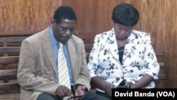 Treza Namathanga Senzani and her husband are shown in the courtroom shortly after her sentencing, Blantyre, Malawi, Oct. 8, 2014. (David Banda/VOA)