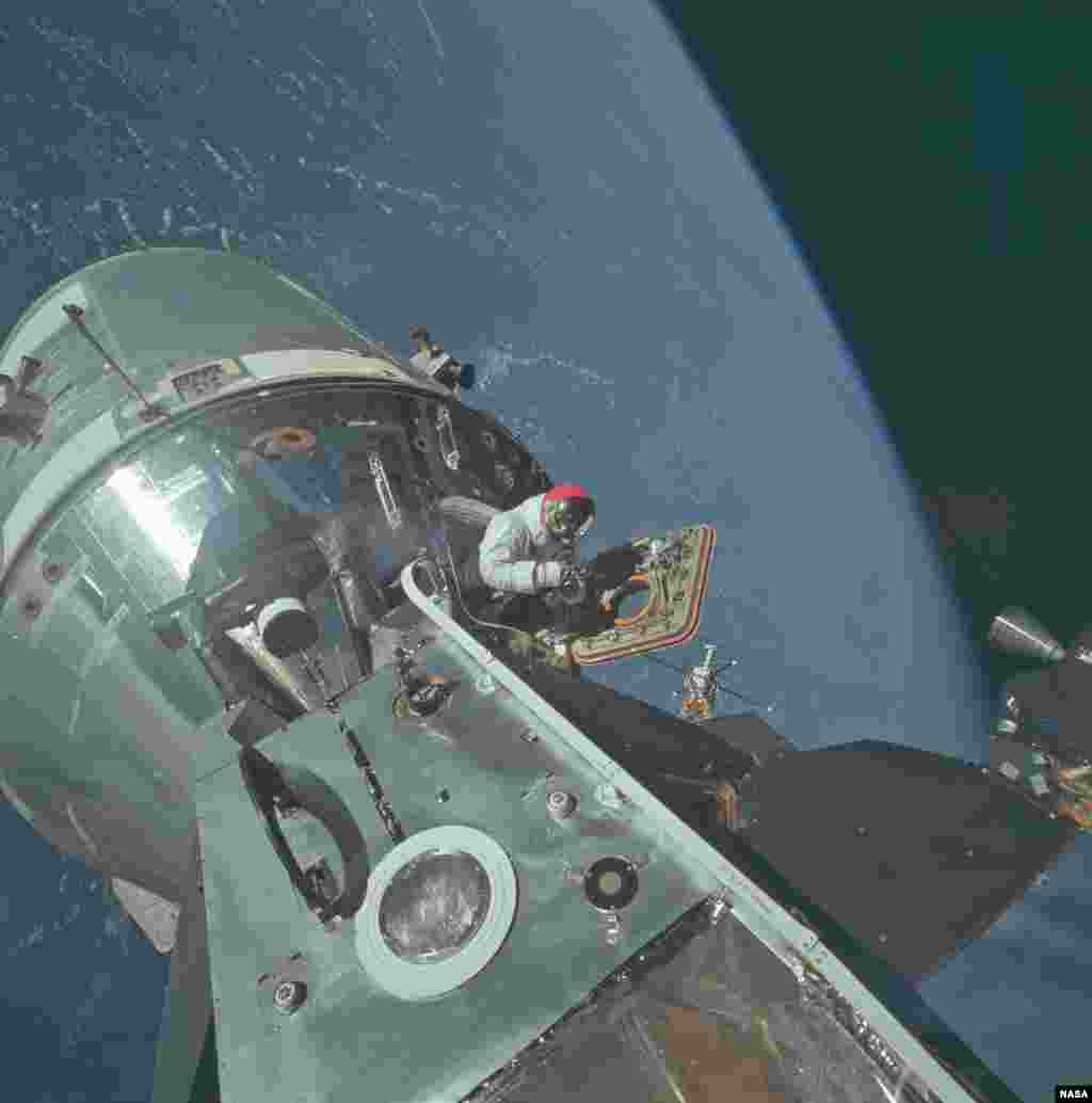 The docked Apollo 9 command and service modules and lunar module conduct the first docking maneuvers in space. Apollo 9 was launched on March 3, 1969. This image was taken on the fourth day of the Apollo 9 Earth-orbital mission by lunar module pilot Russell L. Schweickart of David Scott, command module pilot, in the open hatch of the module. This is one of more than 8,400 high resolution images of Apollo mission that NASA released on Flickr.