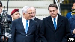 Israeli Prime Minister Benjamin Netanyahu (C-L) receives Brazilian President Jair Bolsonaro (C-R) at Tel Aviv Ben Gurion International Airport, March 31, 2019, in his first state visit to Israel. 
