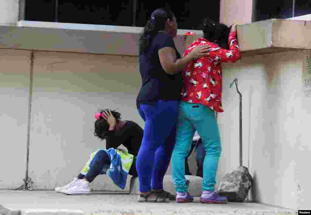 Relatives of one of the inmates killed during a fight between armed gangs at El Porvenir prison, react outside the morgue, in Tegucigalpa, Honduras, Dec. 23, 2019.