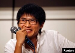 FILE - Han Han, 27, one of China's most popular bloggers based on his website's registered hits, attends a news conference during the Hong Kong Book Fair, July 22, 2010.