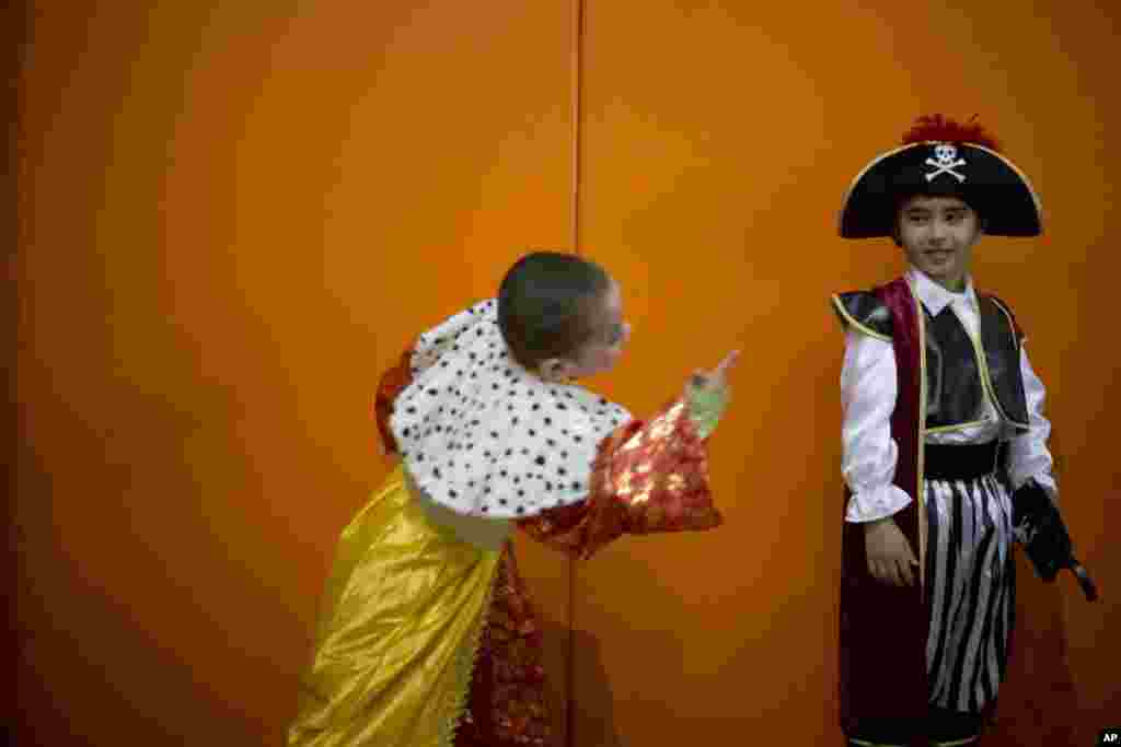 Young children of foreign migrant workers wear costumes during a Purim party in Tel Aviv, Israel.