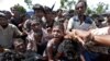  A boy is pulled to safety as Rohingya refugees scuffle while queueing for aid at Cox's Bazar, Bangladesh, Sept. 26, 2017. 