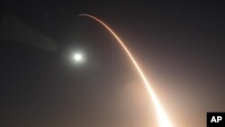 In this image taken with a slow shutter speed and provided by the U.S. Air Force, an unarmed Minuteman 3 intercontinental ballistic missile launches during an operational test just after midnight, Wednesday, May 3, 2017, at Vandenberg Air Force Base, Cali