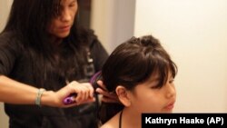 Lexi Country brushes the hair of her daughter, Malea Country, before school in Helena, Montana. 