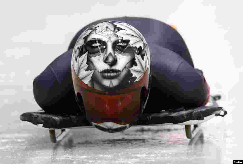 Canada's Sarah Reid speeds down the track during a women's skeleton training session at the Sanki sliding center in Rosa Khutor, a venue for the 2014 Winter Olympics, near Sochi, Russia.