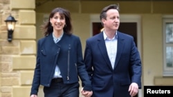 Britain's Prime Minister David Cameron is joined by his wife Samantha during a campaign visit to a home building scheme in Lancaster, northern England, May 6, 2015. 