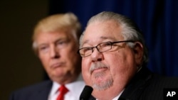 FILE - Sam Clovis speaks during a news conference as then-Republican presidential candidate Donald Trump, left, watches before a campaign rally in Dubuque, Iowa, Aug. 25, 2016. 