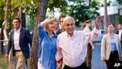 Former Chilean President and current presidential candidate Sebastian Pinera waves before voting during presidential elections runoff in Santiago, Chile, Sunday, Dec. 17, 2017. 