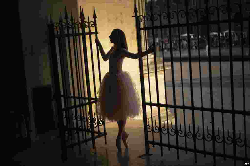 A ballerina dances at the Louvre pyramid in Paris as a heat wave hits the French capital.