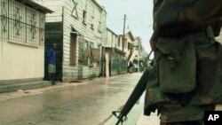 A Belize Defense Force officer guards a deserted street in Belize City. (File)