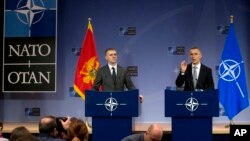 NATO Secretary General Jens Stoltenberg (R) and Montenegro's Foreign Minister Igor Luksic address a media conference at NATO headquarters in Brussels Dec. 2, 2015. 